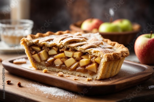 sweet apple pie with white sugar sprinkles on a wooden tray and blurred background, homemade apple pie, apple pie on a wooden table, apple pie with cinnamon photo