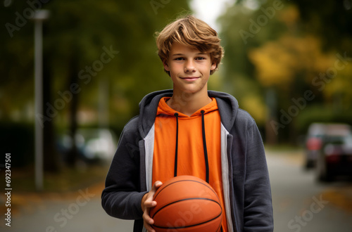 Teenager with basketball on suburban street