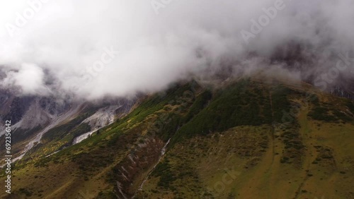 Breathtaking epic Mountain Alps landscape in Austria, peaks covered by clouds photo