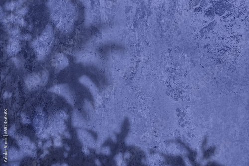 Shadow of leaves on purple blue concrete wall texture with roughness and irregularities. Abstract trendy colored nature concept background. Copy space for text overlay, poster mockup flat lay  photo