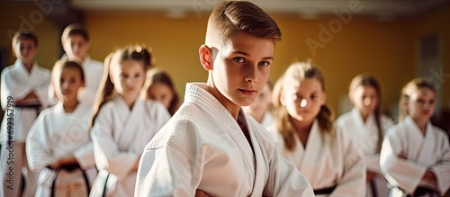 Teenagers and their instructor practicing judo in a dojo at a sports gym.