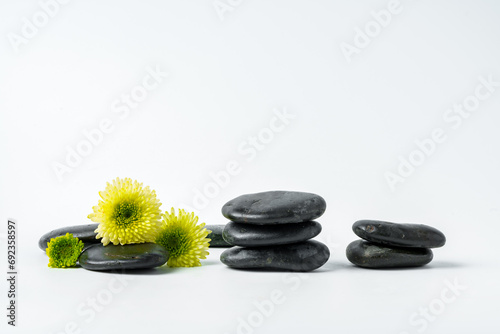 Spa stones and flowers on the white background