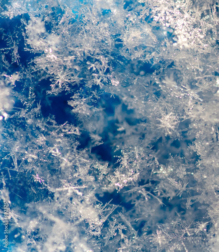 Close-up of snowflakes on a blue background. Macro