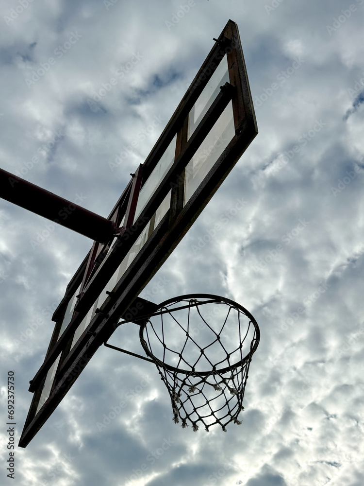 Basketball hoop against the background of the sky with clouds Basketball hoop against the background of the sky with clouds