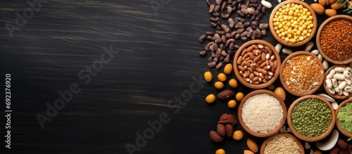 Top-down view of wooden table showcasing diverse assortment of cereals, seeds, beans, and grains. photo