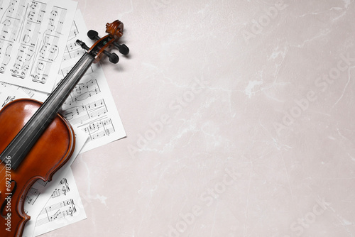 Violin and music sheets on grey marble table, top view. Space for text © New Africa