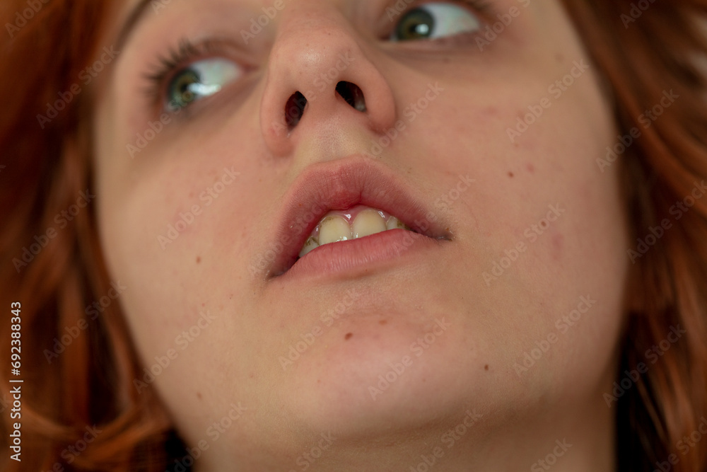 close-up portrait of a pensive teenage girl with red hair with a stylish anime hairstyle close-up portrait of a pensive teenage girl with red hair with a stylish anime hairstyle