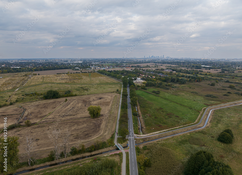 The road through meadows towards Warsaw, near Pęcice, Poland