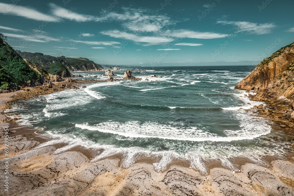 This image captures the raw, wild beauty of Playa del Silencio, an iconic beach in the north of Spain. This image captures the raw, wild beauty of Playa del Silencio, an iconic beach in the north of Spain.