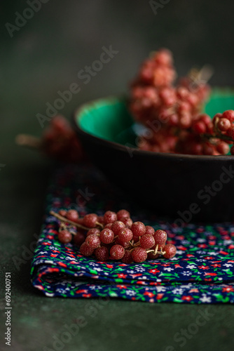 Close-up of fresh ripe buffaloberries (bullberries) on a bowl and folded napkin photo