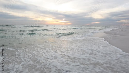 A scenic view of the Gulf Coast National Seashore in Pensacola, Florida. Serene scenery of ocean waves crashing on the beach.