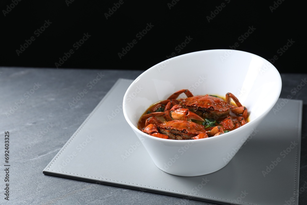 Delicious boiled crabs with sauce on grey table, space for text Delicious boiled crabs with sauce on grey table, space for text