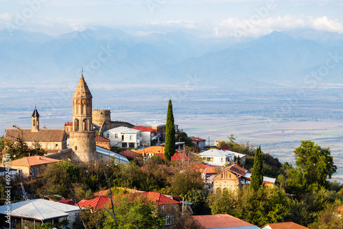 travel to Georgia - Sighnaghi town with cathedral over Alazan valley in Kakheti region in Georgia on sunny autumn evening photo