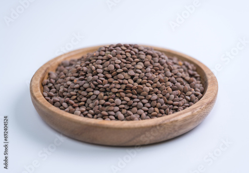 Lentils, beans, wooden plate, close-up, white background