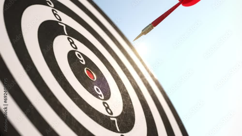 Slow motion of Red Arrow darts shoots on center point of dartboard on blue sky background. 3D animation. Idea concept. Selective focus.