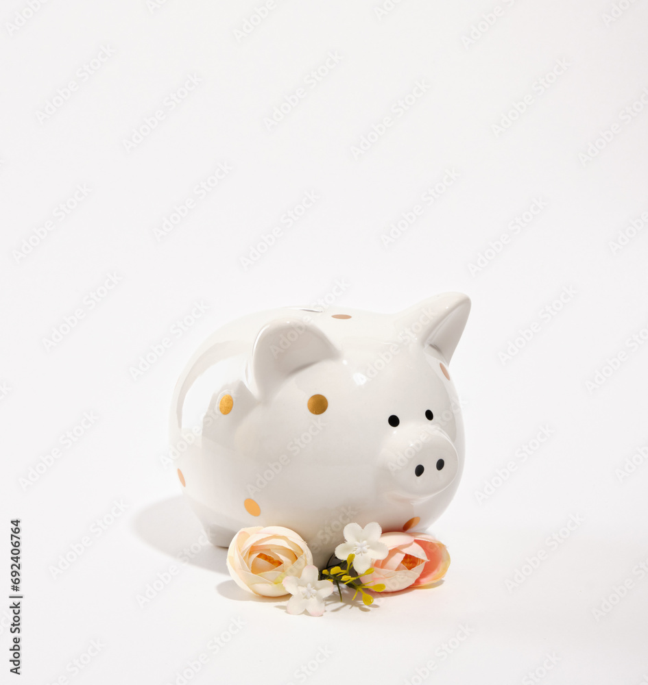 Beautiful piggy bank and summer chic flowers. Money saving and deposit investment. Beautiful piggy bank and summer chic flowers. Money saving and deposit investment.