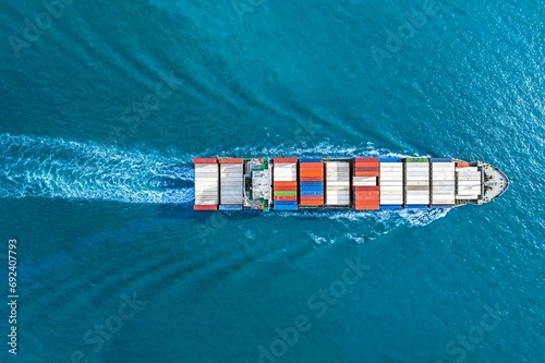 Aerial top view container ship vessel cargo carrier at blue sea.