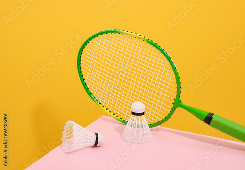 Green badminton racket and white shuttlecocks. Play and sport. photo
