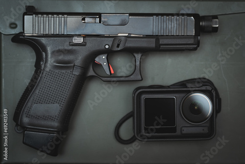 G19 pistol and action camera, close-up photo.