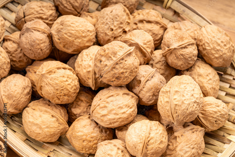 Walnuts kernels in wooden basket on wooden table. Walnuts kernels in wooden basket on wooden table.