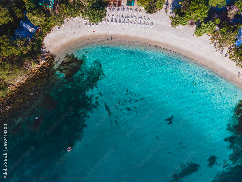 Koh Samet Island Thailand, aerial drone view from above at the Samed Island in Thailand with a turqouse colored ocean and a white tropical beach at a hidden bay on the island