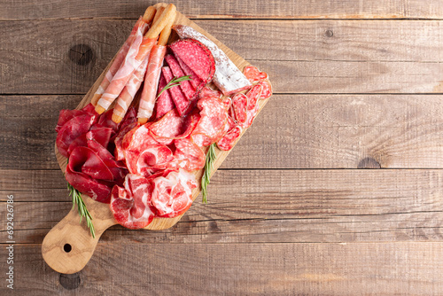 Charcuterie board. Antipasti appetizers of meat platter with salami, prosciutto crudo or jamon and olives.