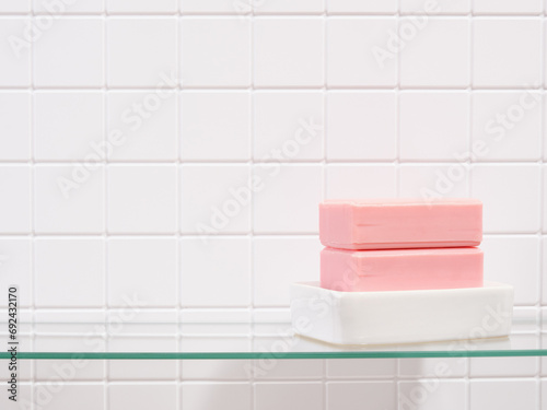 Pink natural soap on a white soap dish. Copy space for text.