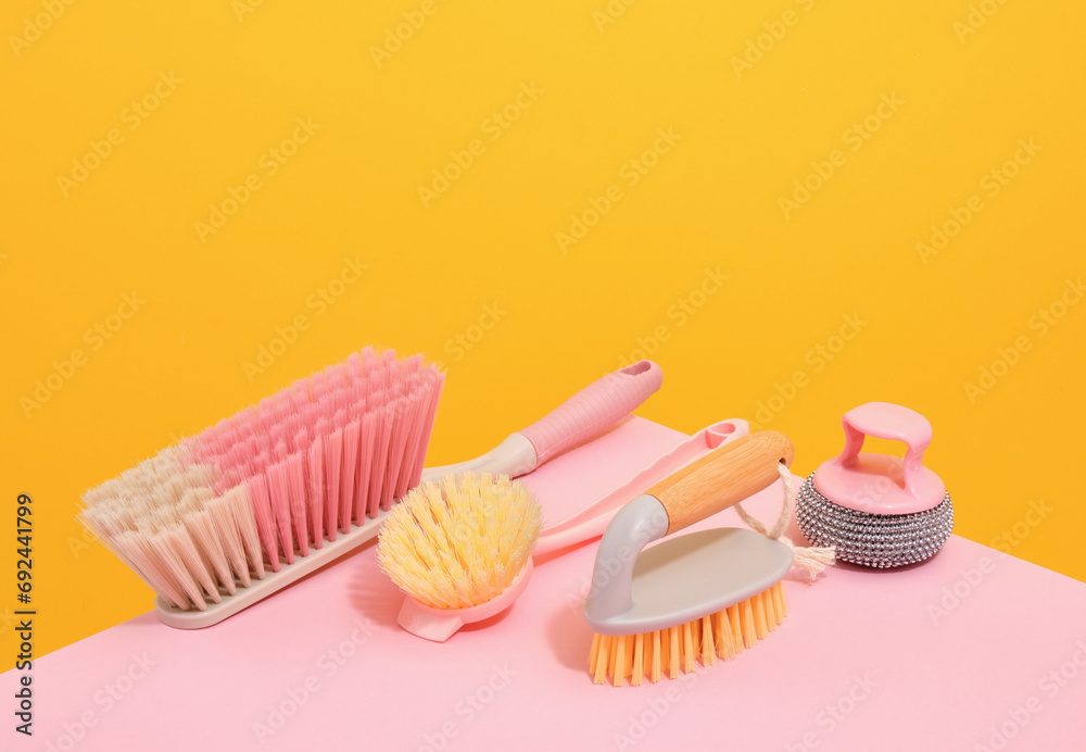 Cleaning brushes with different bristles lie on the table, an abrasive sponge for dirty surfaces. Cleaning brushes with different bristles lie on the table, an abrasive sponge for dirty surfaces.