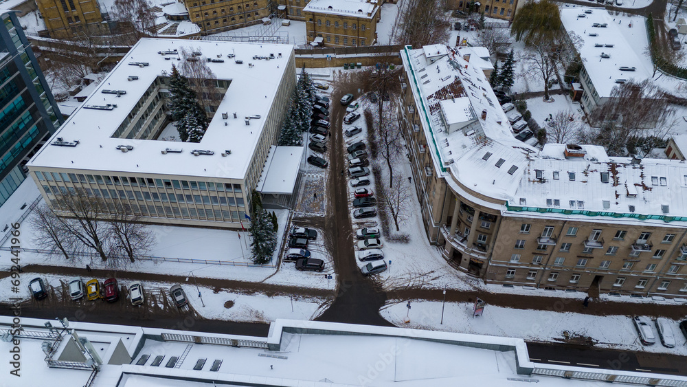 Drone photography of city street and surrounding buildings in snow