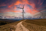 Scenery mountain in winter with a wind farm at sunset Wind turbines for green economy and technology are the only solution to protect the planet from climate change and global warming natural industry
