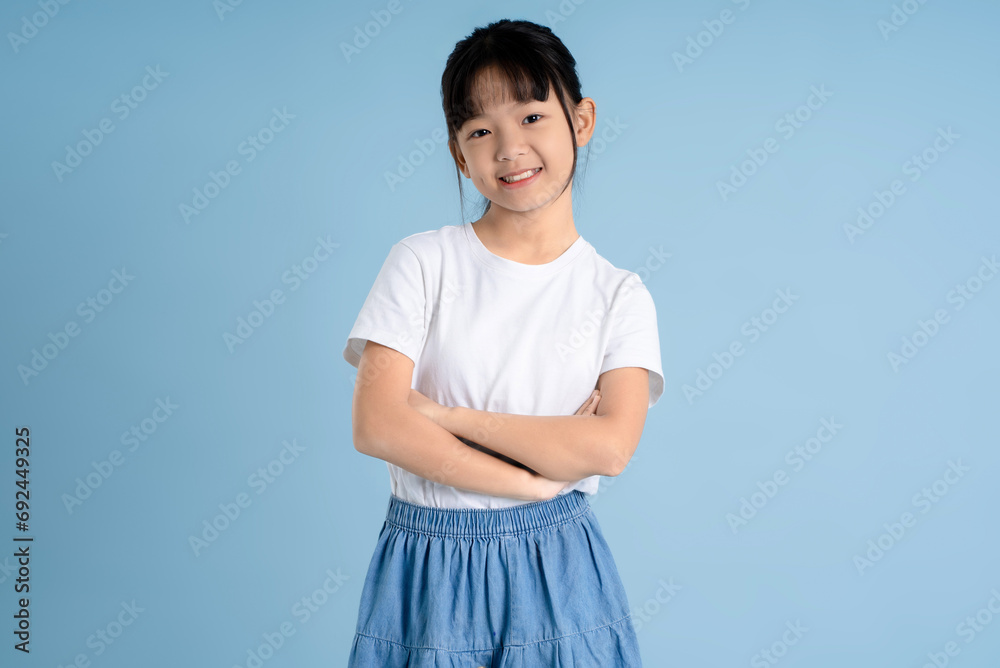 Portrait of Asian girl posing on blue background Portrait of Asian girl posing on blue background