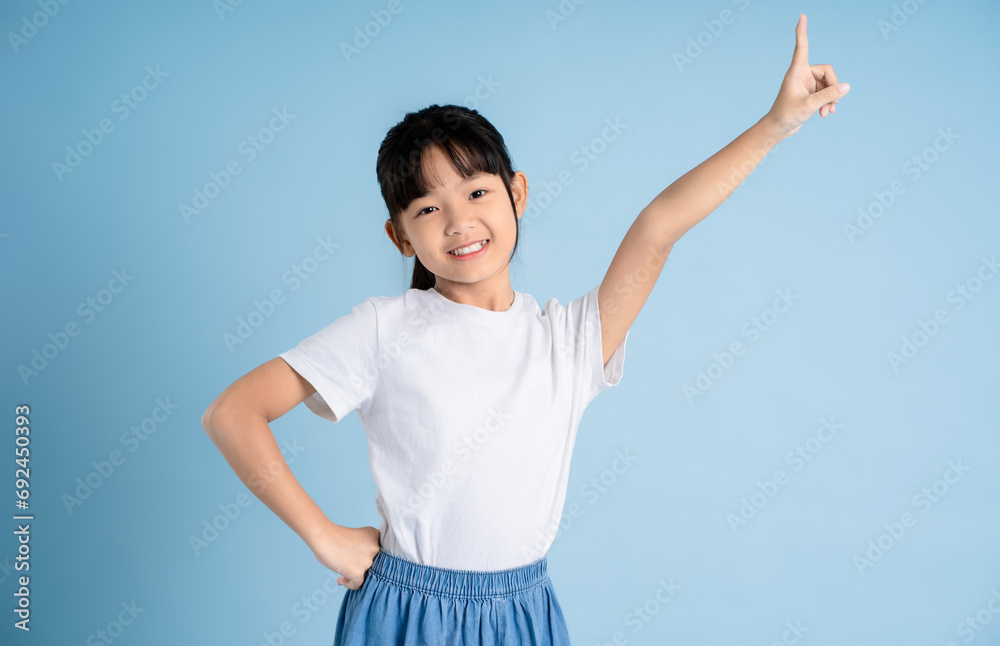 Portrait of Asian girl posing on blue background Portrait of Asian girl posing on blue background