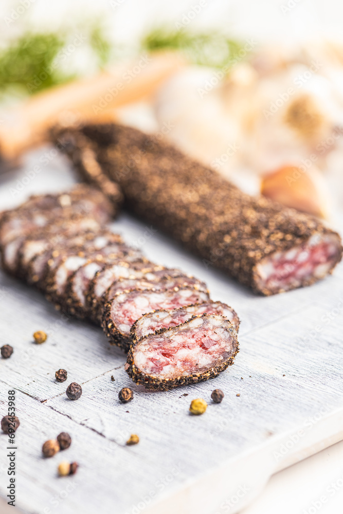 Smoked dried sausage. Sliced sausage on cutting board. Smoked dried sausage. Sliced sausage on cutting board.
