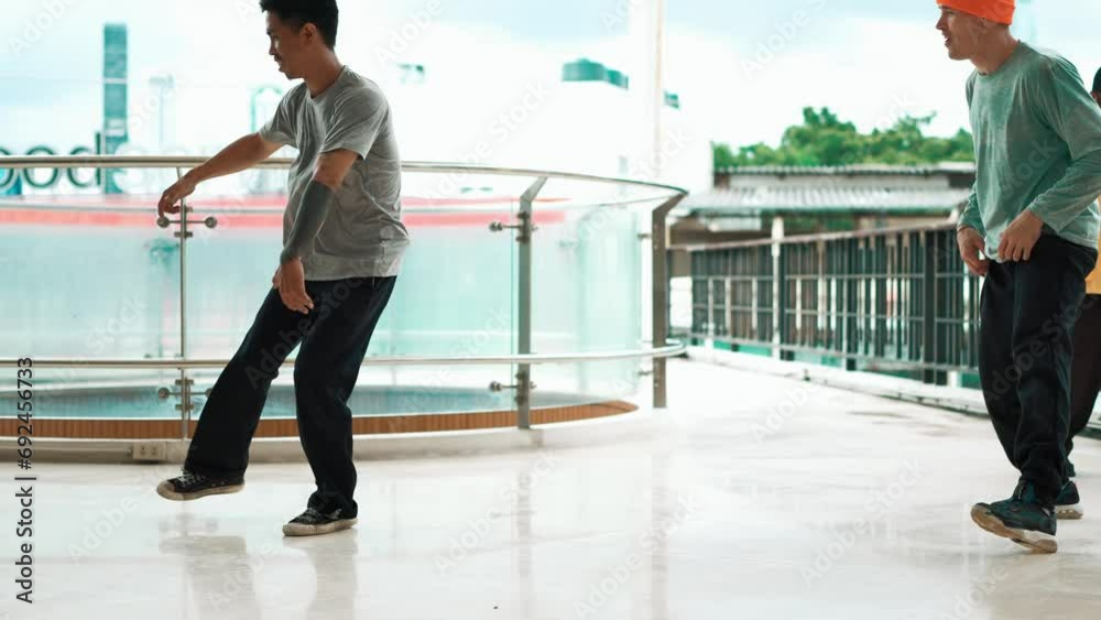 Boyzone Dancing Hip-hop teenager group perform b-boy dance at mall corridor with city ...
