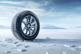 Car wheel on snow in winter landscape.