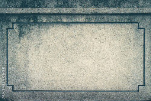 A rectangle frame on a wall. Toned image.