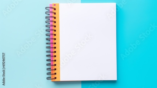 a spiral bound notebook with a white paper on it