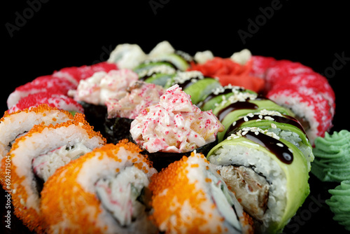 Sushi set of various sushi rolls on a black background