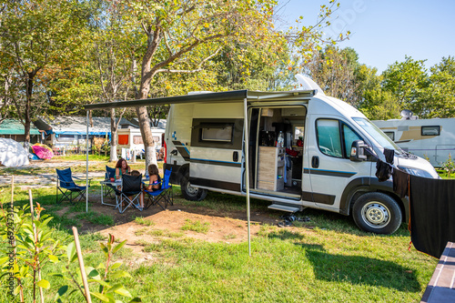 Family camping with a campervan in campsites in Greece or Croatia.