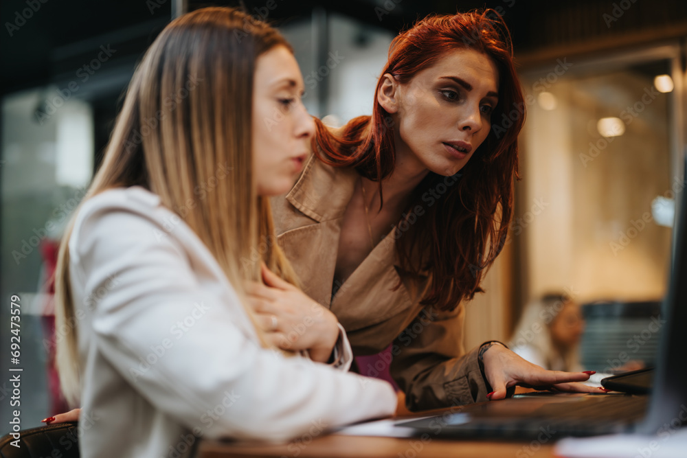 Female, business partners collaborating in a coffee bar, discussing business strategies and data analytics. Female, business partners collaborating in a coffee bar, discussing business strategies and data analytics.