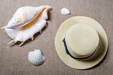 vacation flat view with straw hat and sea shellssea shells