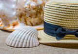 vacation still life with straw hat and sea shells