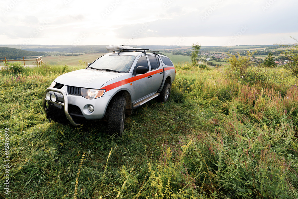 A rescue car stands in the middle of the field in summer