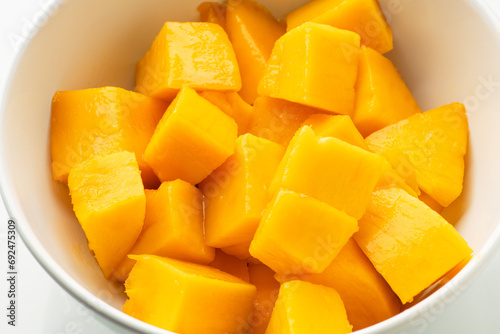 Ripe sweet mango slices in a bowl