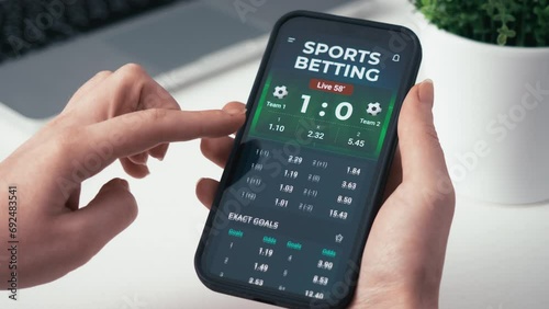 Making online bet on a gambling app. Watching live football score broadcast on a gambling smartphone application and gambling. Internet gambling concept. photo