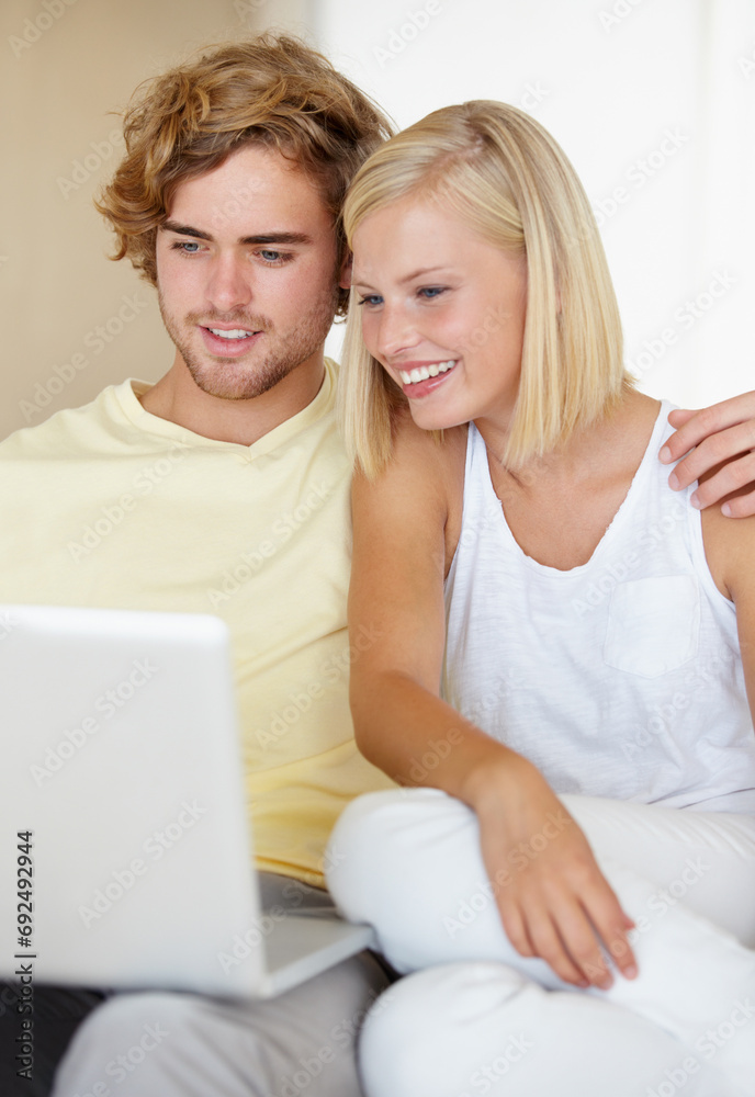 Laptop, love and happy couple relax in a house streaming movies, video or film, show or social media together. Tech, search and people in living room with online entertainment for weekend or vacation