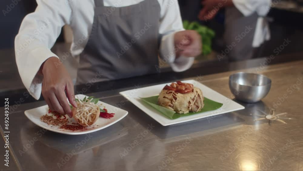 Cropped shot of unrecognizable cook in apron serving plate with dish for hotel restaurant guests Cropped shot of unrecognizable cook in apron serving plate with dish for hotel restaurant guests