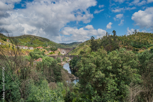 Trees and vegetation and river Zêzere with old bridge and Bouçã dam in the background, Pedrogão Grande PORTUGAL photo