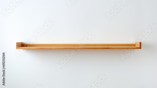 Minimalist wooden shelf on a clean white wall background with copy space