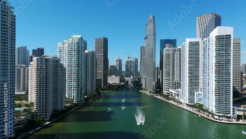 City skyline with tall buildings and skyscrapers. Miami River divided downtown on two neighborhoods. Blue sky providing beautiful backdrop to urban landscape photo
